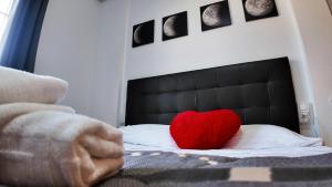 a red heart pillow sitting on top of a bed at Apartalux Vista Mar in La Manga del Mar Menor