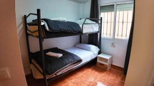 a room with two bunk beds and a window at Apartalux Vista Mar in La Manga del Mar Menor +61 photos