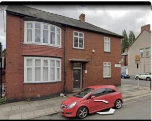 a red car parked in front of a brick house at Levy Nook 8 in Darlington