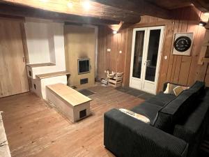 a living room with a couch and a tv at La grange du Taillat in Campan