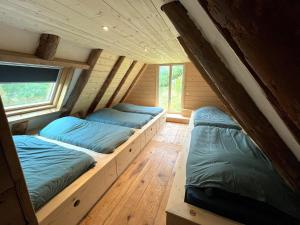 a room with two beds in a cabin at La grange du Taillat in Campan