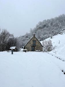 an old barn is covered in snow at La grange du Taillat in Campan +12 photos