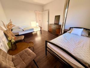 a bedroom with two beds and a table and a chair at Priestranný apartmán s veľkorysým výhľadom in Rača