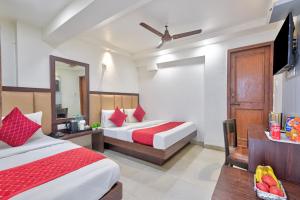 a hotel room with two beds and a television at Hotel Maharani -New Delhi Railway Station - Paharganj in New Delhi