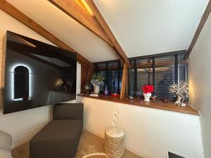 a living room with a couch and a window at Luxury Double Room in Chislehurst