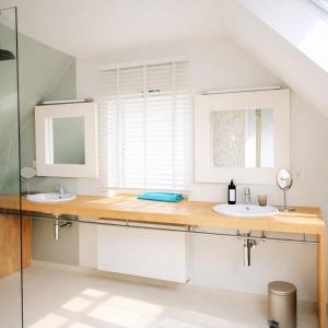 a bathroom with two sinks and a mirror at B&B Lisdodde in Lissewege