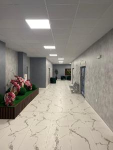 an empty hallway in a building with flowers on the walls at BALKAN TOWER- Apartment Viktoria in Gabrovo