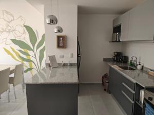 a kitchen with a sink and a counter top at Arévalo - D2 in Cipolletti +1 photo