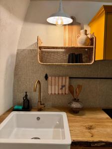 a kitchen with a white sink in a kitchen at Kupolinis namelis in Kilova II +65 photos