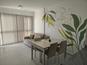 a dining room with a table and a flower mural at Arévalo - D2 in Cipolletti