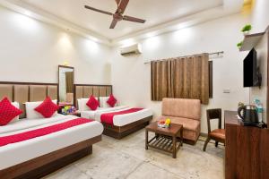 a hotel room with two beds and a chair at Hotel Maharani -New Delhi Railway Station - Paharganj in New Delhi +37 photos