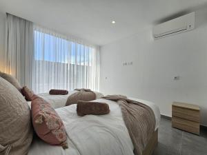 a bedroom with two beds and a large window at AUX VILLAS DE MICK in Callao Salvaje +30 photos