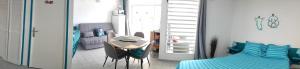 a room with a bed and a table and a couch at TOUMALACAÏ Appart 238 in Folle Anse