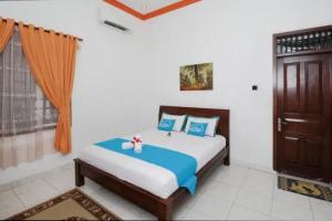 a bedroom with a bed and a window at Guest House Pogung Baru in Yogyakarta