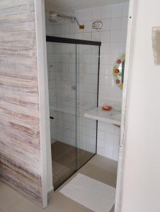 a shower with a glass door in a bathroom at Vila Luiza Ubatuba in Ubatuba +28 photos