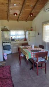 a kitchen with a table and some chairs and a table and a kitchen at Soñada San Rafael in San Rafael