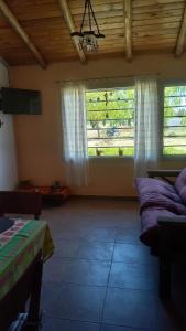 a living room with two windows and a couch at Soñada San Rafael in San Rafael