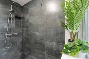 a gray bathroom with a shower and a plant at Cosy Anfield Home in Liverpool +61 photos