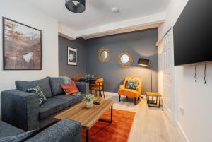 a living room with a couch and a table at Cosy Anfield Home in Liverpool