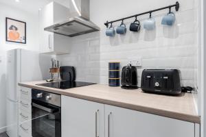 a kitchen with a counter top with a toaster and appliances at Cosy Anfield Home in Liverpool