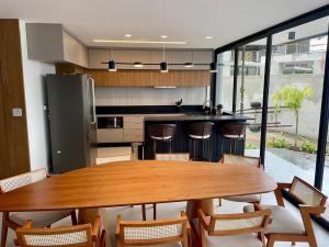 a kitchen with a wooden table and some chairs at Angra casa in Angra dos Reis