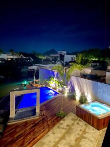 a villa with a swimming pool at night at Angra casa in Angra dos Reis