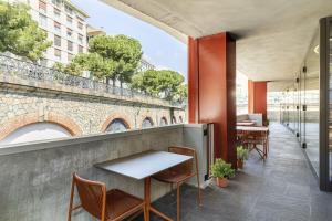 a restaurant with a table and chairs on a balcony at B&B Hotel Genova City Center in Genoa