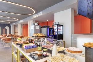 a bakery with many different types of food on display at B&B Hotel Genova City Center in Genoa