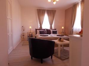 a living room with a couch and a table at Éden Villa - Garden Apartmanok in Balatonfüred