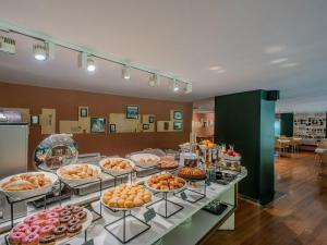 a buffet with many different types of pastries on display at B&B Hotel Firenze City Center in Florence
