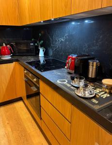 a kitchen with a black counter top with a toaster oven at Bliss in Braddon in Braddon