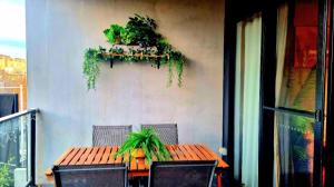 a table with two chairs and a plant on a wall at Bliss in Braddon in Braddon +8 photos