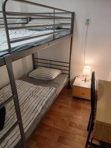 a bunk bed room with two bunk beds and a desk at Smart hostel in Belgrade +52 photos