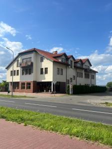 a large white building on the side of a road at Alabastro in Tomaszów Mazowiecki