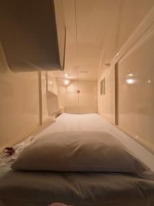 a bedroom with a large white bed in a room at Capsule Hotel Sauna G -topia male Only in Funabashi +18 photos