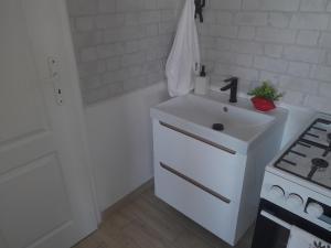 a white kitchen with a sink and a stove at Biela Magnólia in Vrbov +47 photos