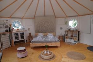 a large room with a bed in a tent at Hotel & Glamping Gerhardhof by ALPAMI in Wildermieming