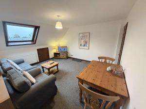 a living room with a couch and a table at Millbrook House Apartments 2 in Milton