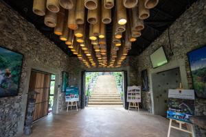 a hallway with wooden bowls hanging from a building at The Rock Lodge in Ban Nahin-Nai (1)