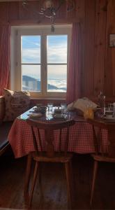 a table in a room with a tablecloth on a table at Pension Fernsicht in Außerteuchen