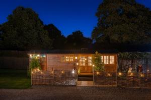 a house with lights in the yard at night at Ockeridge Rural Retreats in Worcester