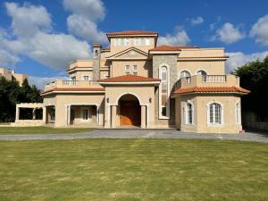 a large brick house with a large yard at Evermond Suites in Alexandria