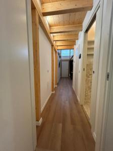 a hallway in a house with wood ceilings at Loft bridge in Ascoli Piceno
