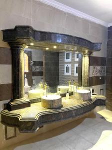 a bathroom with a large mirror and sinks at Evermond Suites in Alexandria +7 photos