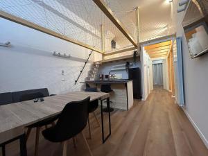 a dining room with a wooden table and chairs at Loft bridge in Ascoli Piceno