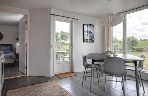 a kitchen and dining room with a table and chairs at Stendala Gård in Gärsnäs