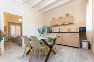 a kitchen and dining room with a table and chairs at Potamos Apartments in Sidari