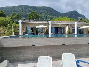 a villa with a swimming pool and a house at OCEAN DREAM-Beach House in Phú Quốc