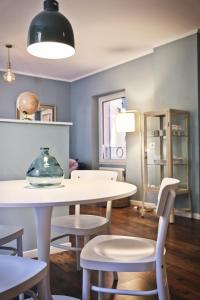 a dining room with a white table and chairs at Varennahouse in Varenna