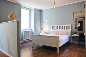 a bedroom with a white bed and a window at Varennahouse in Varenna